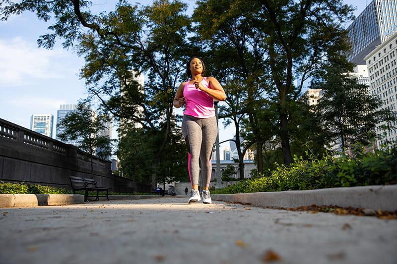 woman walking on sidewalk downtown