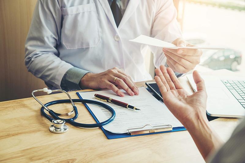 doctor handing lab results to patient